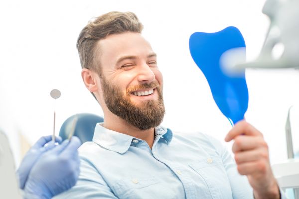 Man smiling in a dental chair