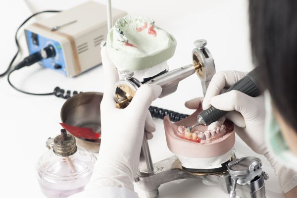 Dentist working on dentures