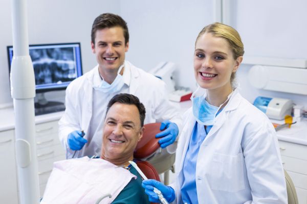 dentists and patient smiling
